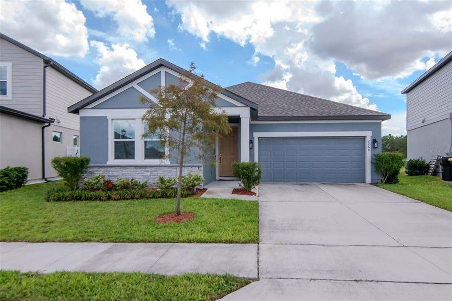 Front exterior of a new home in , Davenport, FL, highlighting curb appeal (Image 1).