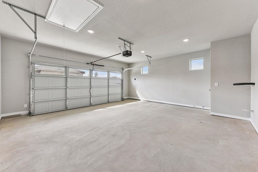 Garage featuring recessed lighting and a garage door opener Garage featuring recessed lighting and a garage door opener