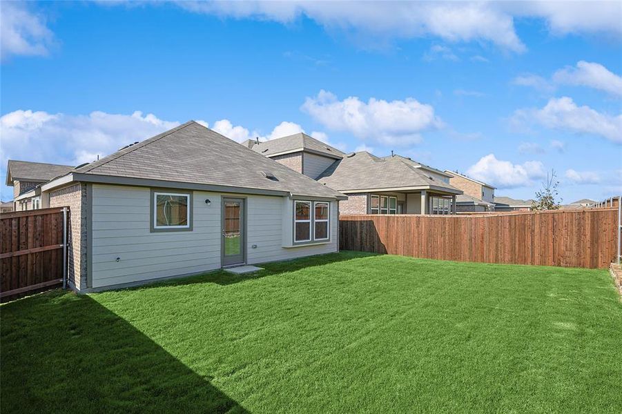 Back of house featuring a lawn