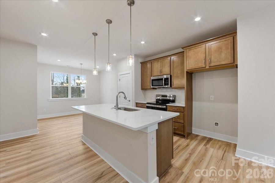 Chef-inspired kitchen with brown warm cabinets