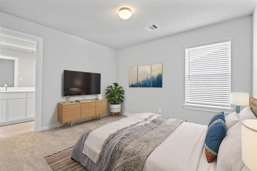 Secondary bedroom features plush carpet, neutral paint, large window with privacy blinds, and access to its own private secondary bathroom.