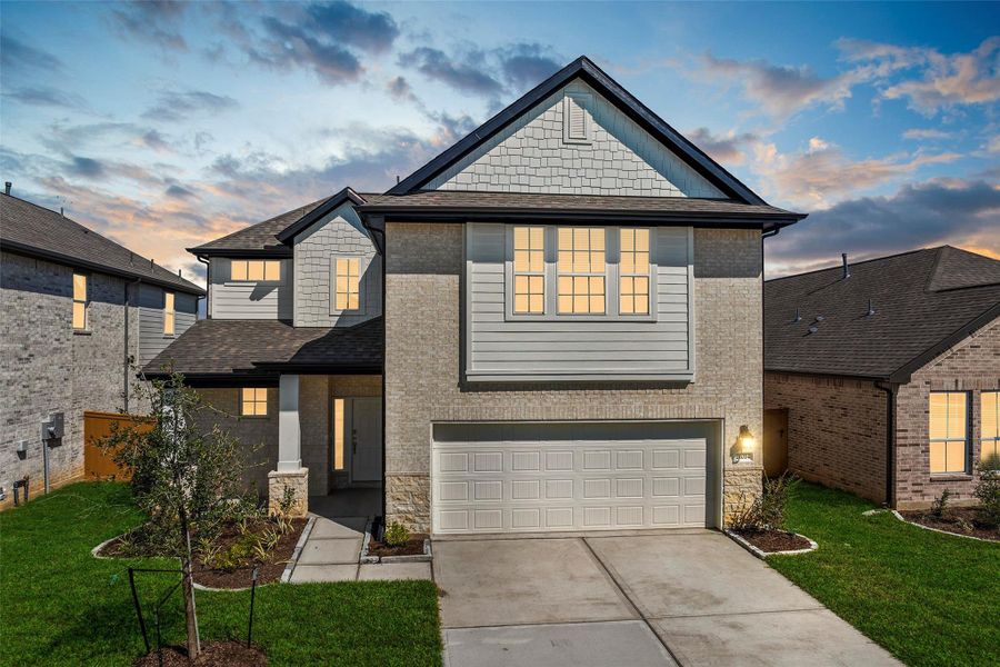 Beautifully designed front elevation with charming curb appeal, showcasing manicured landscaping and a welcoming covered entryway.
