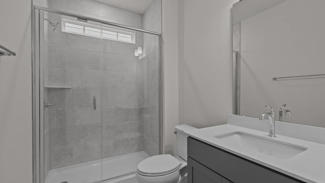 Burton Design convenient secondary bathroom with high-end finishes, at Lakeside Glen by premier builder DRB Homes in York, SC