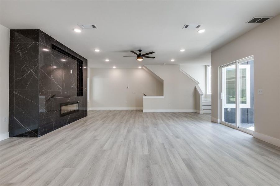Unfurnished living room featuring ceiling fan, light wood-style flooring, and recessed lighting