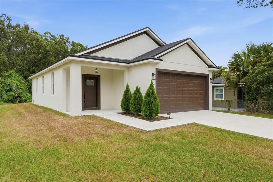 Front exterior of a new home in , Orlando, FL, highlighting curb appeal (Image 24).