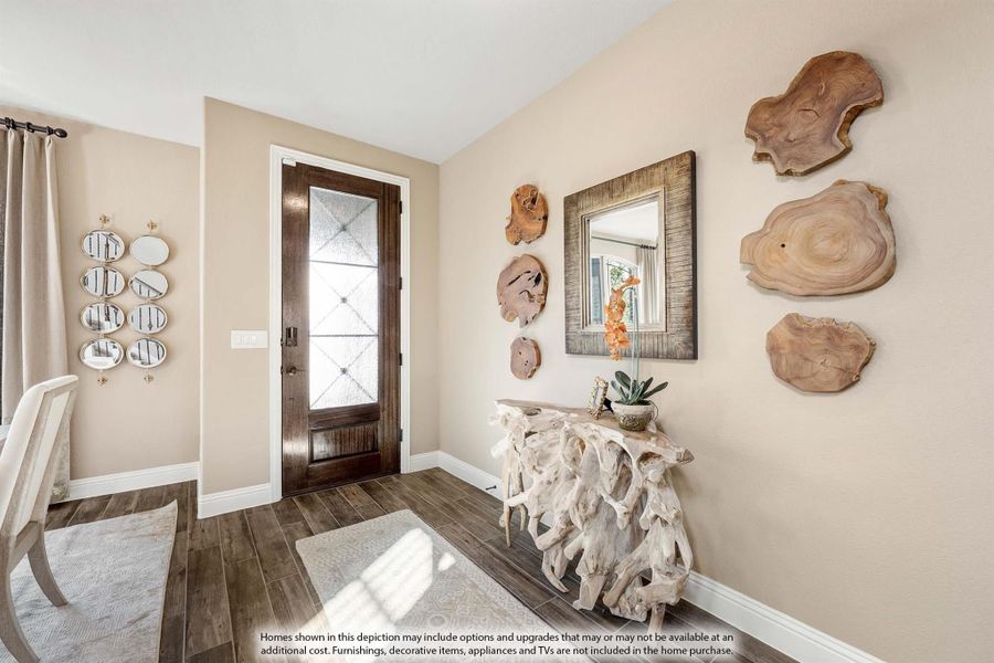 Home entryway with dark wood front door, wood-slice wall art, and a rustic driftwood console table on hardwood floors Home entryway with dark wood front door, wood-slice wall art, and a rustic driftwood console table on hardwood floors
