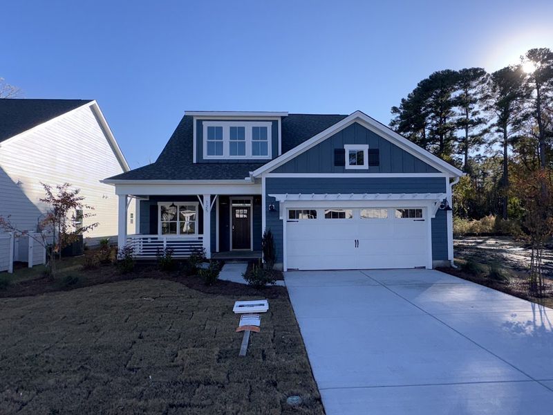 Front exterior of a new home in Riverside Cove, Wilmington, NC, highlighting curb appeal (Image 1).