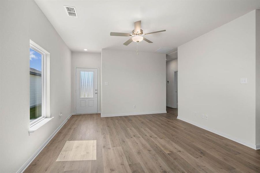 Spare room featuring light wood-style floors and a ceiling fan