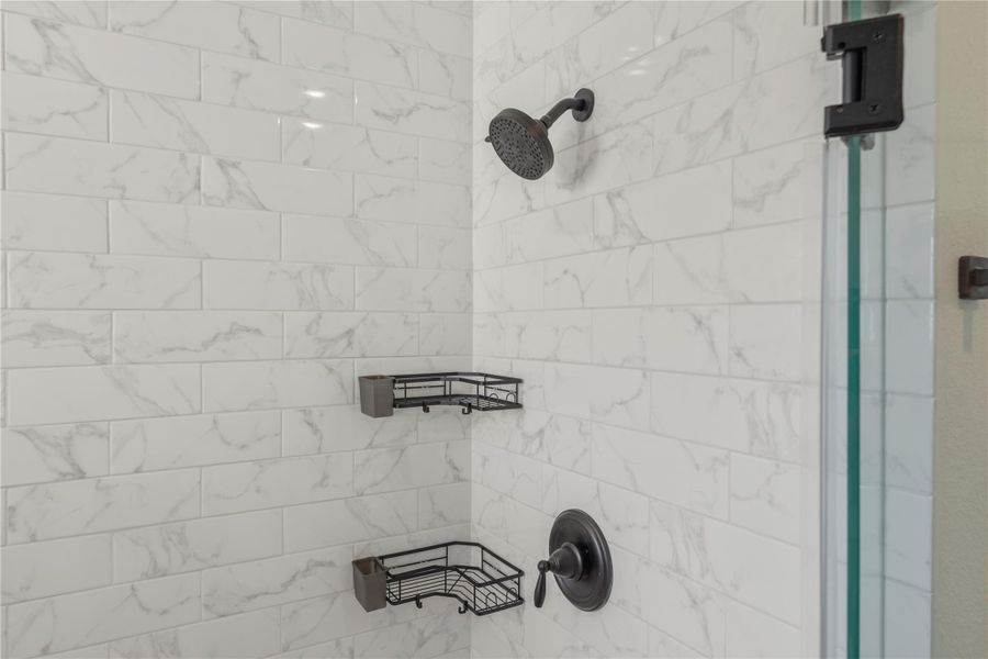 Matching tile work in the shower provides consistency in design. Matching tile work in the shower provides consistency in design.