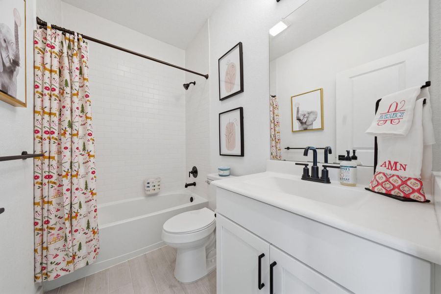 One of two Secondary Bathrooms. bathroom features a clean, modern design  It has a bathtub/ shower combo a sleek fixtures. Ideal for families or guests.