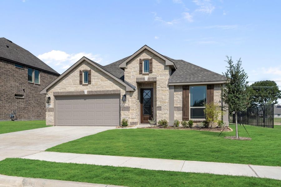 Single-story home with stone exterior, two-car garage, and manicured front lawn