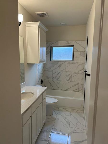 Bathroom featuring, bathing tub  shower combination, and vanity.