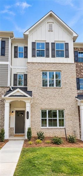 Front exterior of a new home in Townes at South Main, Kennesaw, GA, highlighting curb appeal (Image 2). Front exterior of a new home in Townes at South Main, Kennesaw, GA, highlighting curb appeal (Image 2).