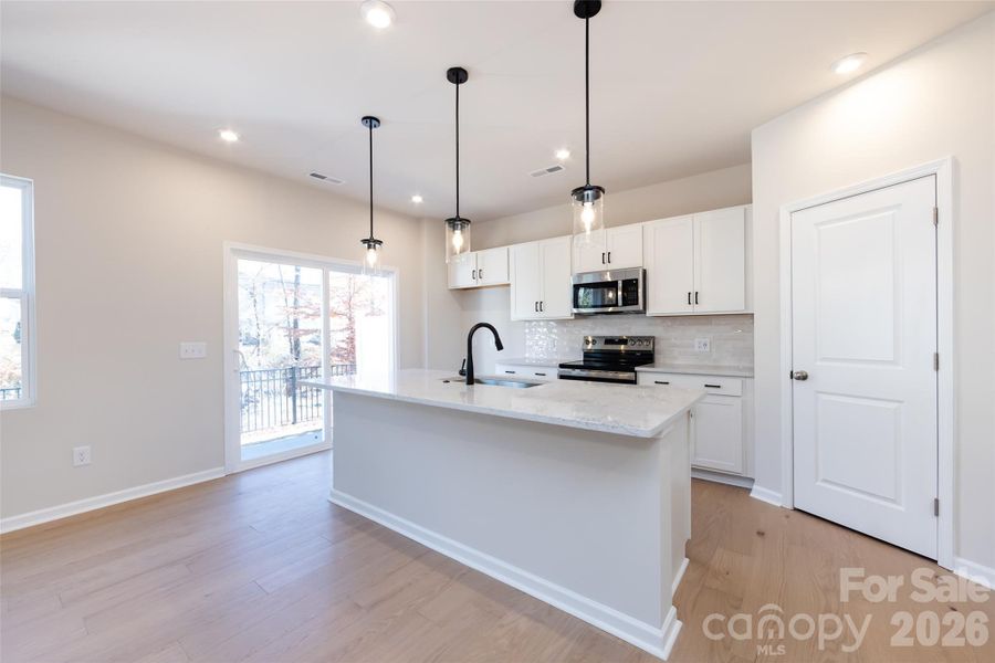 Chef-Inspired Kitchen with White Cabinets and Quartz Countertops