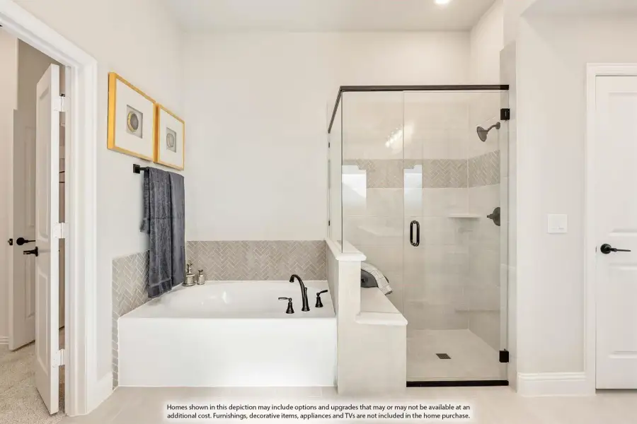 Master bathroom with soaking tub, glass walk-in shower, and herringbone tile accents