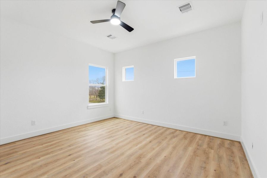 One of three spacious bedroom on the second floor. Each complete with a ceiling fan and large walk-in closet with built in drawers!