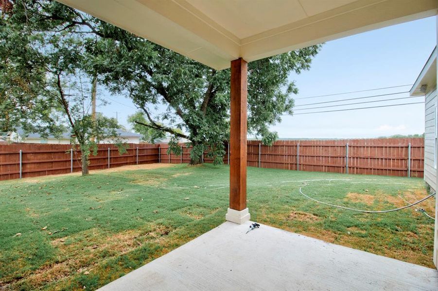 Fenced backyard with a patio area