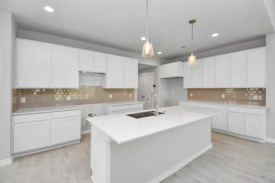 Culinary haven, featuring granite countertops, a tile backsplash, stainless steel appliances (to be installed), and 42” upper cabinets. Sample photo of completed home with similar floor plan. Actual colors and selections may vary. Culinary haven, featuring granite countertops, a tile backsplash, stainless steel appliances (to be installed), and 42” upper cabinets. Sample photo of completed home with similar floor plan. Actual colors and selections may vary.