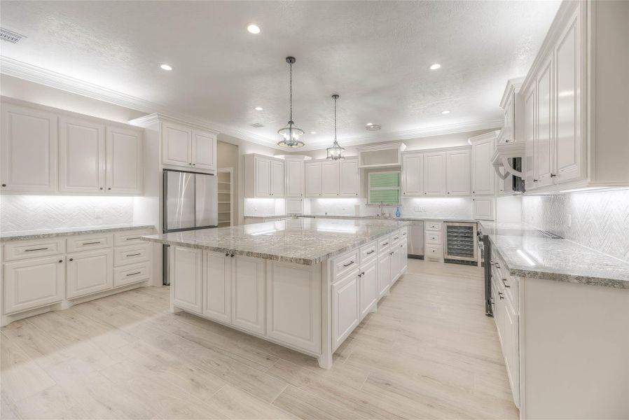 Kitchen with huge granite countertops with an island with plenty of cabinet and counterspace with exceptional lighting Kitchen with huge granite countertops with an island with plenty of cabinet and counterspace with exceptional lighting