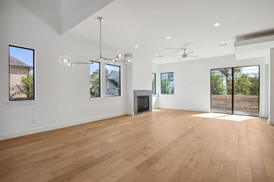 Dining room looking toward family room.  Bask in the natural light of this open floor plan with large floor to ceiling windows.