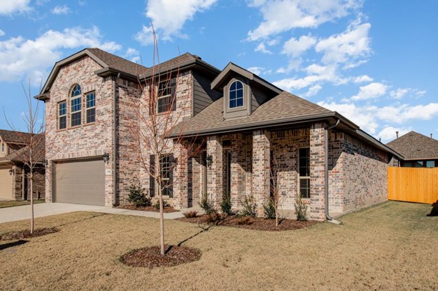 Front exterior of a new home in Mustang Place II, Heartland, TX, highlighting curb appeal (Image 17).
