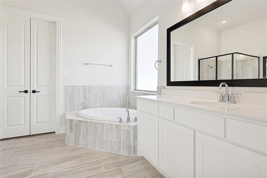 Bathroom featuring vanity and plus walk in shower