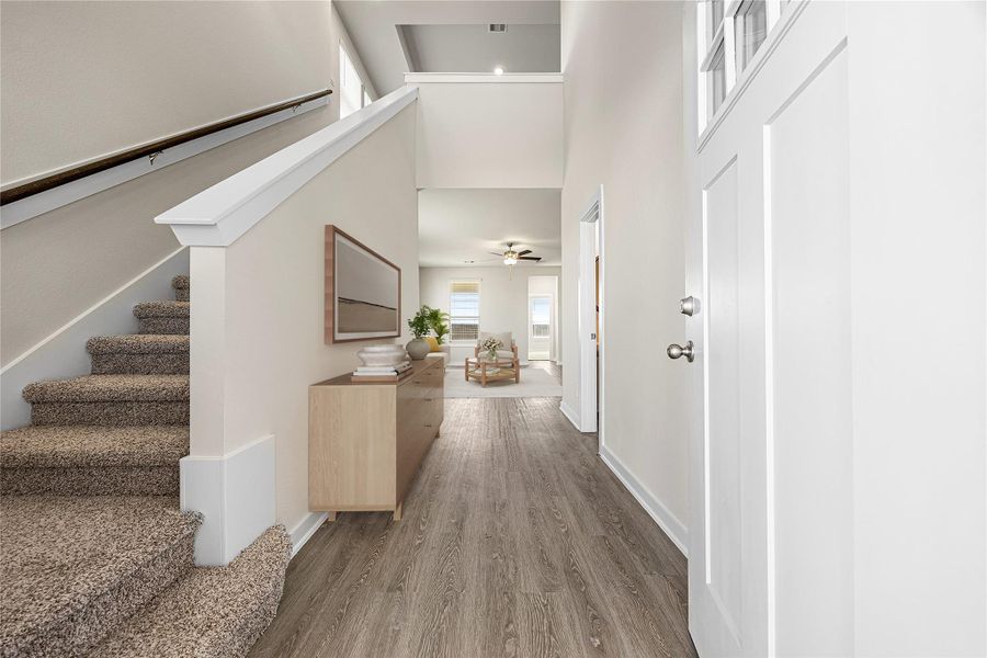 Step into a spacious and welcoming living area with an open-concept layout that flows effortlessly into the kitchen and dining spaces. Neutral tones, recessed lighting, and wide-plank flooring create a modern yet comfortable atmosphere, while large windows fill the room with natural light—perfect for relaxing or entertaining. Step into a spacious and welcoming living area with an open-concept layout that flows effortlessly into the kitchen and dining spaces. Neutral tones, recessed lighting, and wide-plank flooring create a modern yet comfortable atmosphere, while large windows fill the room with natural light—perfect for relaxing or entertaining.