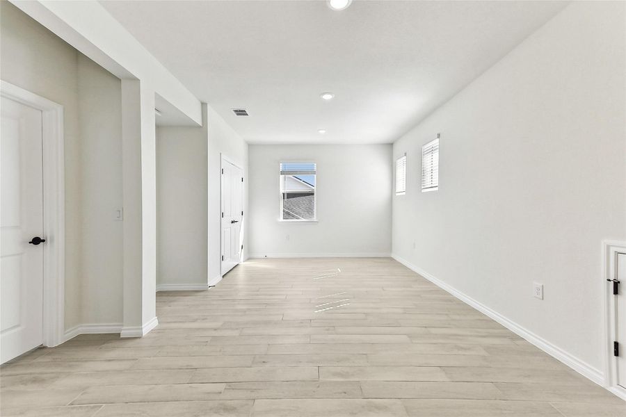 Empty room with visible vents, baseboards, recessed lighting, and light wood finished floors Empty room with visible vents, baseboards, recessed lighting, and light wood finished floors