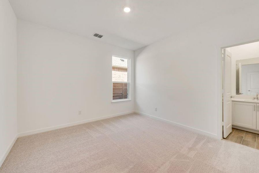 Spare room featuring light carpet and recessed lighting