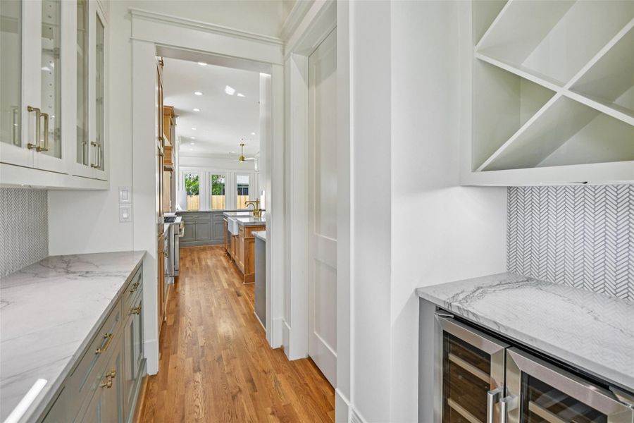 The Butler's Pantry connects the kitchen to the dining room and is the home to the wine station and the kitchen pantry (door to right). The Butler's Pantry connects the kitchen to the dining room and is the home to the wine station and the kitchen pantry (door to right).