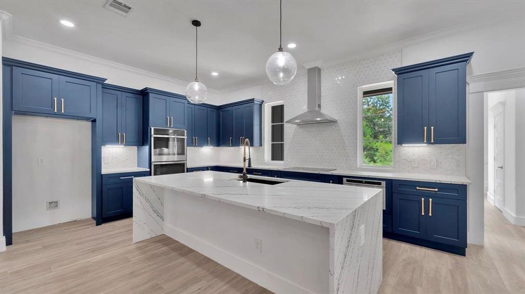 Oversized island provides a breakfast bar, sunk in oversized sink, and plenty of room to move around as you prepare that important meal.