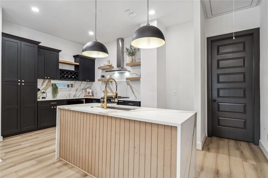 The stunning quartz waterfall island creates a bold statement in the kitchen, blending seamlessly with the modern cabinetry and quartz backsplash