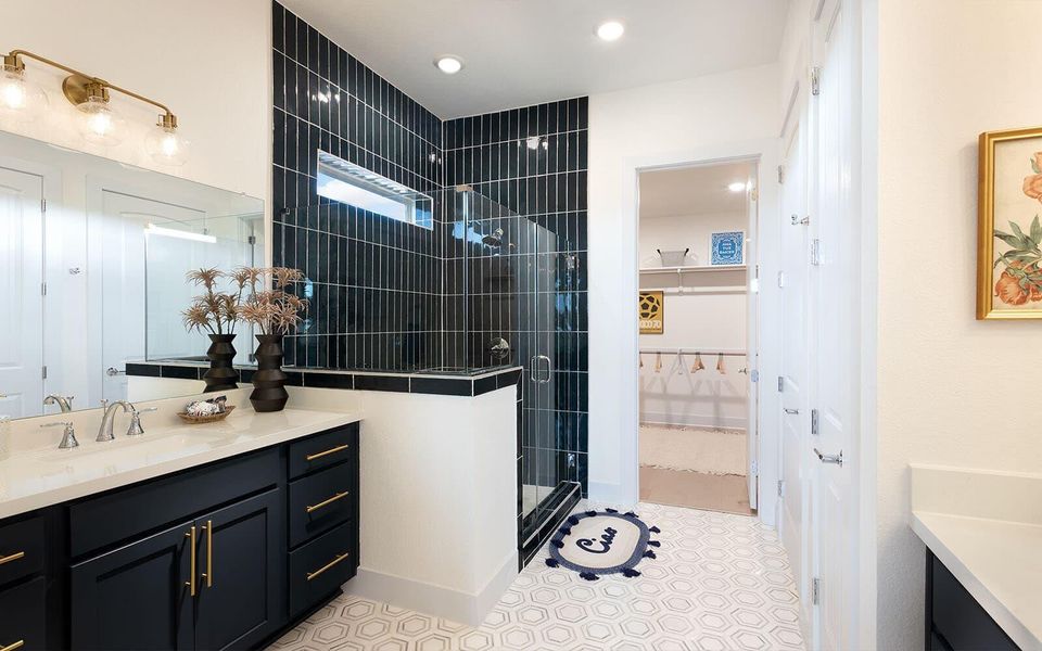 Bold black subway tile defines this modern bathroom, featuring a glass-enclosed shower and sleek vanity. Bold black subway tile defines this modern bathroom, featuring a glass-enclosed shower and sleek vanity.