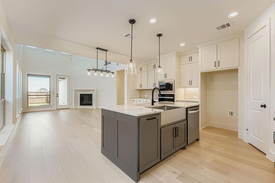 Kitchen featuring gray cabinetry, appliances with stainless steel finishes, white cabinets, light wood-style floors, and recessed lighting Kitchen featuring gray cabinetry, appliances with stainless steel finishes, white cabinets, light wood-style floors, and recessed lighting