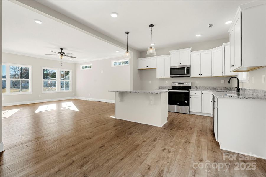 Carolina Heartwood cabinetry with dovetailed drawers, full overlay and soft closure pair with stainless appliances and granite countertops to finish the kitchen in this new home.