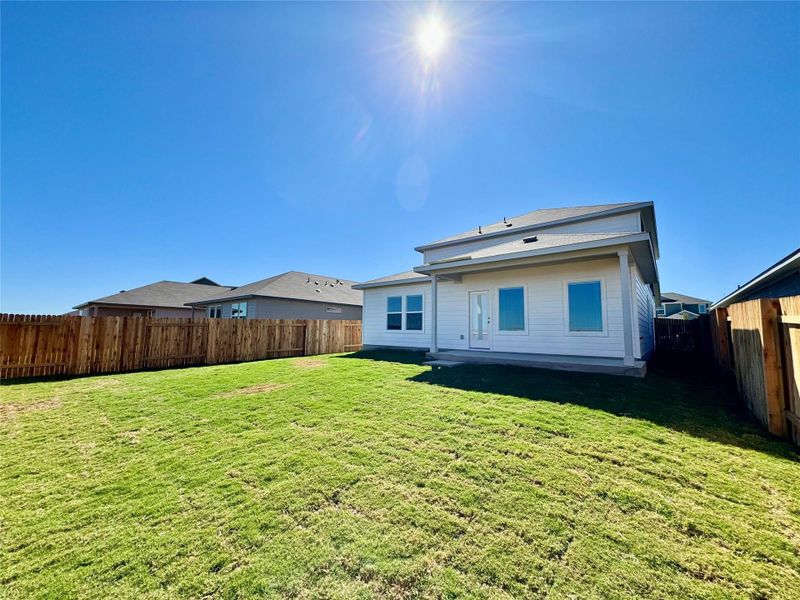 Back of house with a fenced backyard Back of house with a fenced backyard