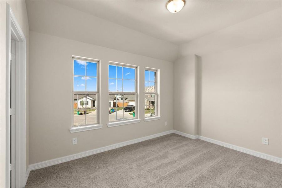 Your secondary bedroom features plush carpet, fresh paint, closet, and a large window that lets in plenty of natural lighting.