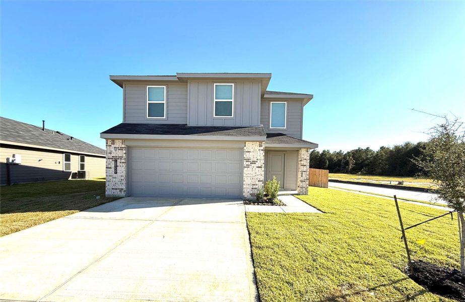 Front exterior of a new home in Porters Mill, New Caney, TX, highlighting curb appeal (Image 1).