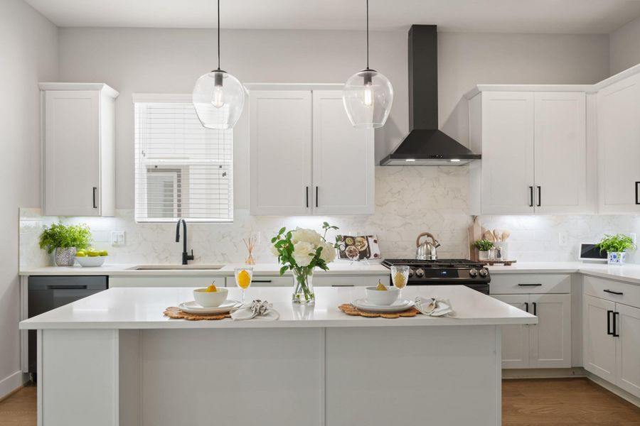 The large island provides additional counter space for meal prep or a casual spot to enjoy a light snack. The large island provides additional counter space for meal prep or a casual spot to enjoy a light snack.