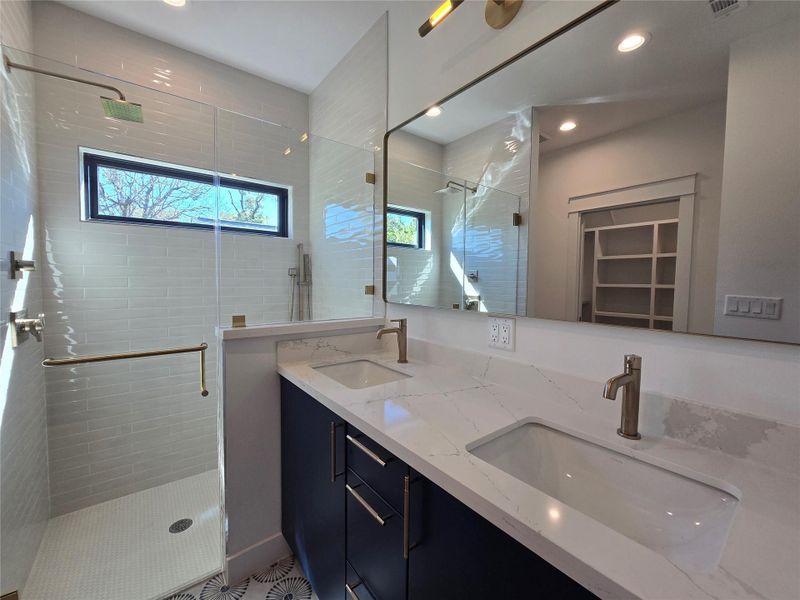 Dual sink vanity, Silestone counter top, and a multi-function shower with overhead shower head, or a handheld handle on a sliding bar - great for reaching all over, or when washing a pet. Dual sink vanity, Silestone counter top, and a multi-function shower with overhead shower head, or a handheld handle on a sliding bar - great for reaching all over, or when washing a pet.