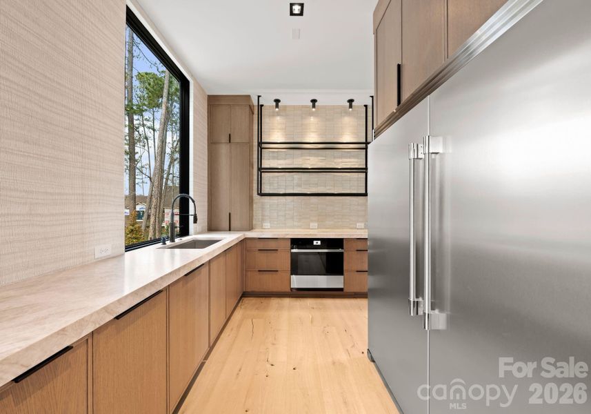 Scullery featuring additional appliances and a walk-in pantry. Scullery featuring additional appliances and a walk-in pantry.