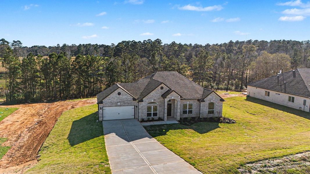 Front exterior of a new home in Rose Hill Estates, Willis, TX, highlighting curb appeal (Image 20).