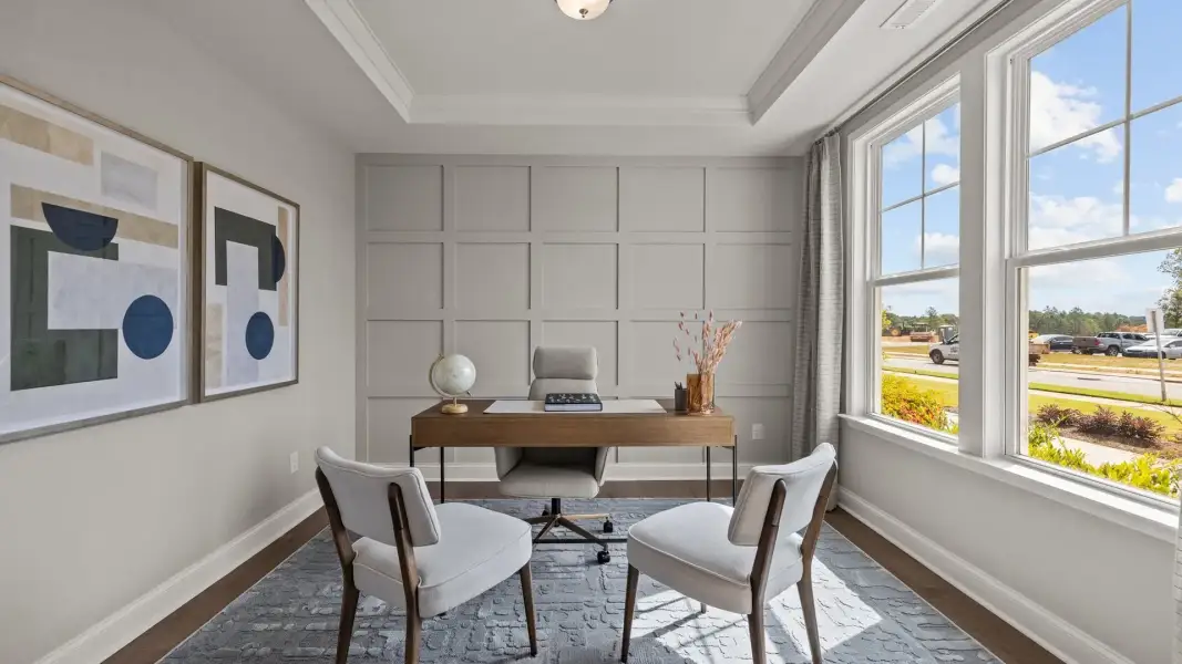 Elegant multi-use study with elevated tray ceiling, large windows, and premium finishes, in the Townsend Design by DRB Homes Elegant multi-use study with elevated tray ceiling, large windows, and premium finishes, in the Townsend Design by DRB Homes