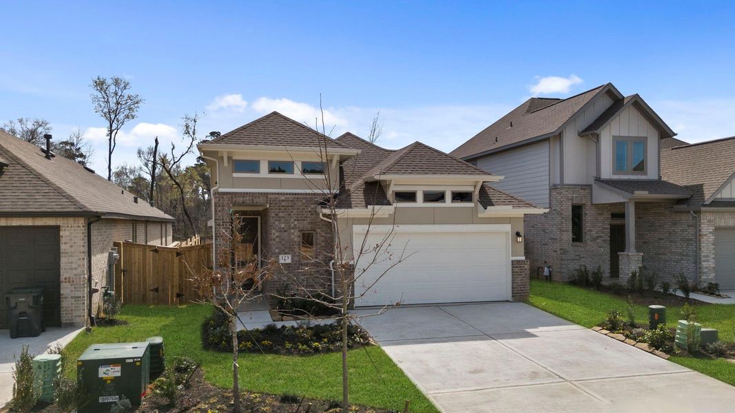 Front exterior of a new home in Grand Central Park, Conroe, TX, highlighting curb appeal (Image 20).