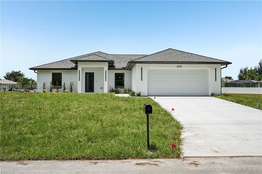Front exterior of a new home in , Cape Coral, FL, highlighting curb appeal (Image 1). Front exterior of a new home in , Cape Coral, FL, highlighting curb appeal (Image 1).