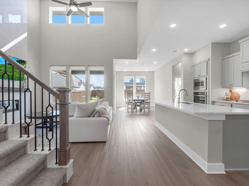 Seamless open concept design with island kitchen, eat in dining, and an abundance of natural lighting pouring into the spacious living area. Seamless open concept design with island kitchen, eat in dining, and an abundance of natural lighting pouring into the spacious living area.