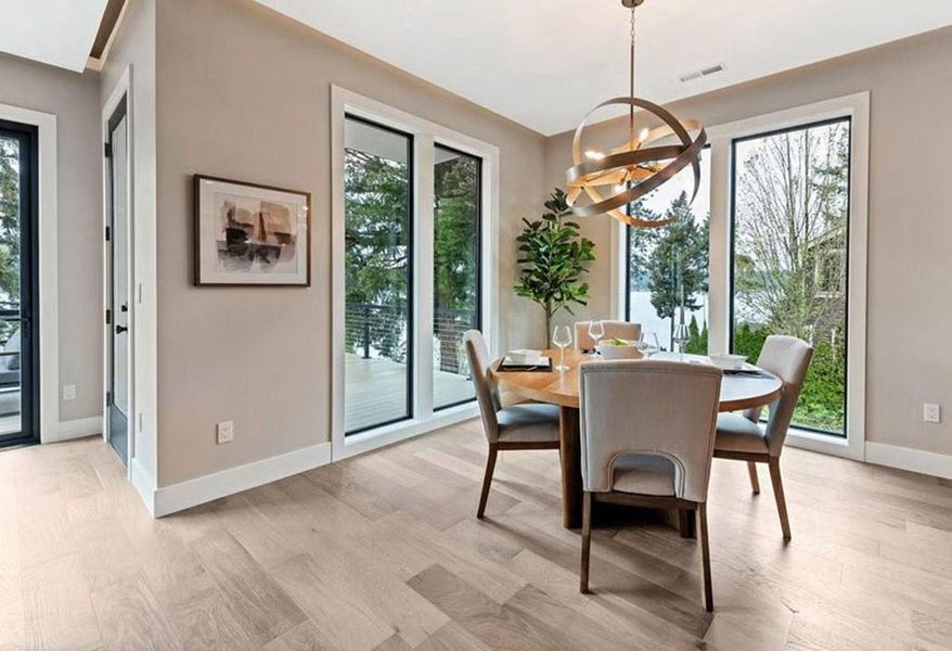 Dining space featuring light wood finished floors and hanging lights