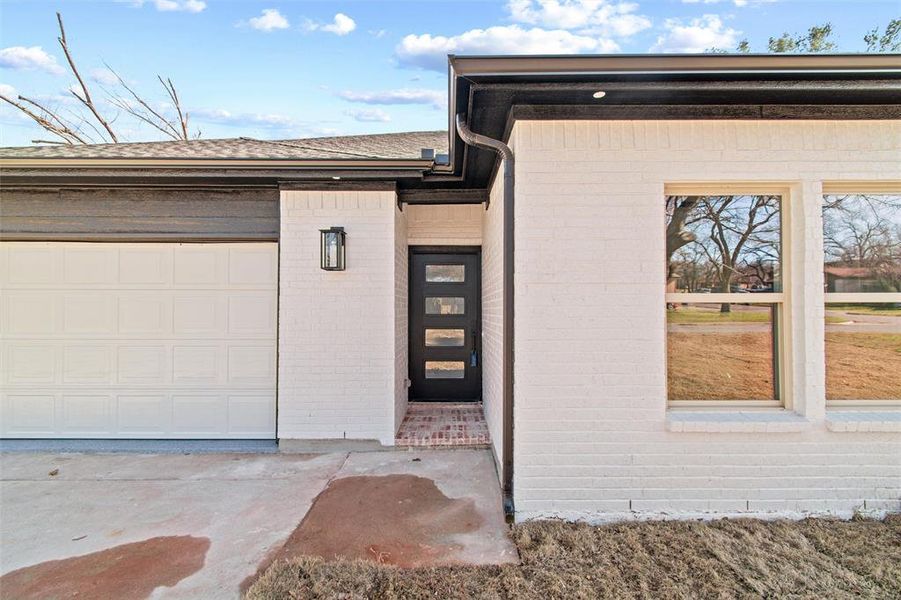 View of exterior entry featuring a garage