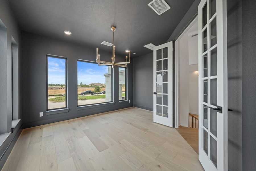 Elevated Study that's tucked away off of the curved staircase with large, clean lined picture frame windows wrapping around the room. Elevated Study that's tucked away off of the curved staircase with large, clean lined picture frame windows wrapping around the room.