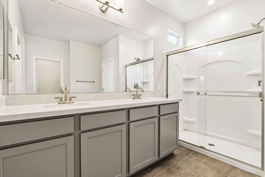 A bathroom with a large mirror.